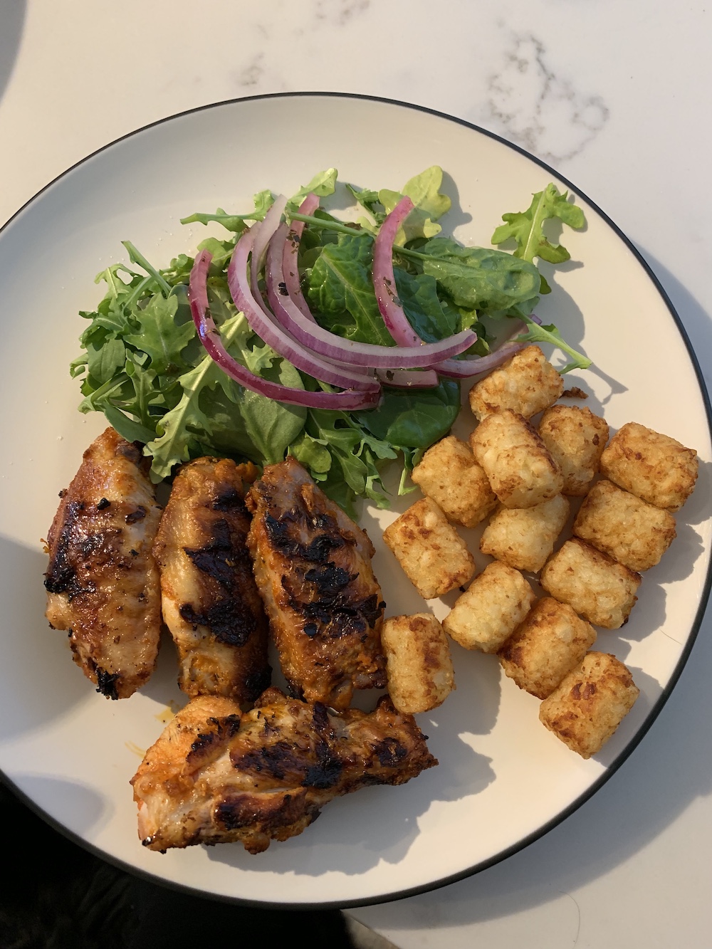 Chicken wings, a green salad with marinated onions and a side of tots. The perfect summer dinner. Easy and Fast!